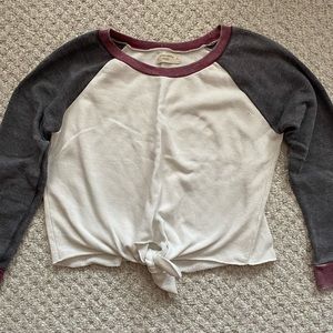 White, grey, and red long sleeve sweater, size small.